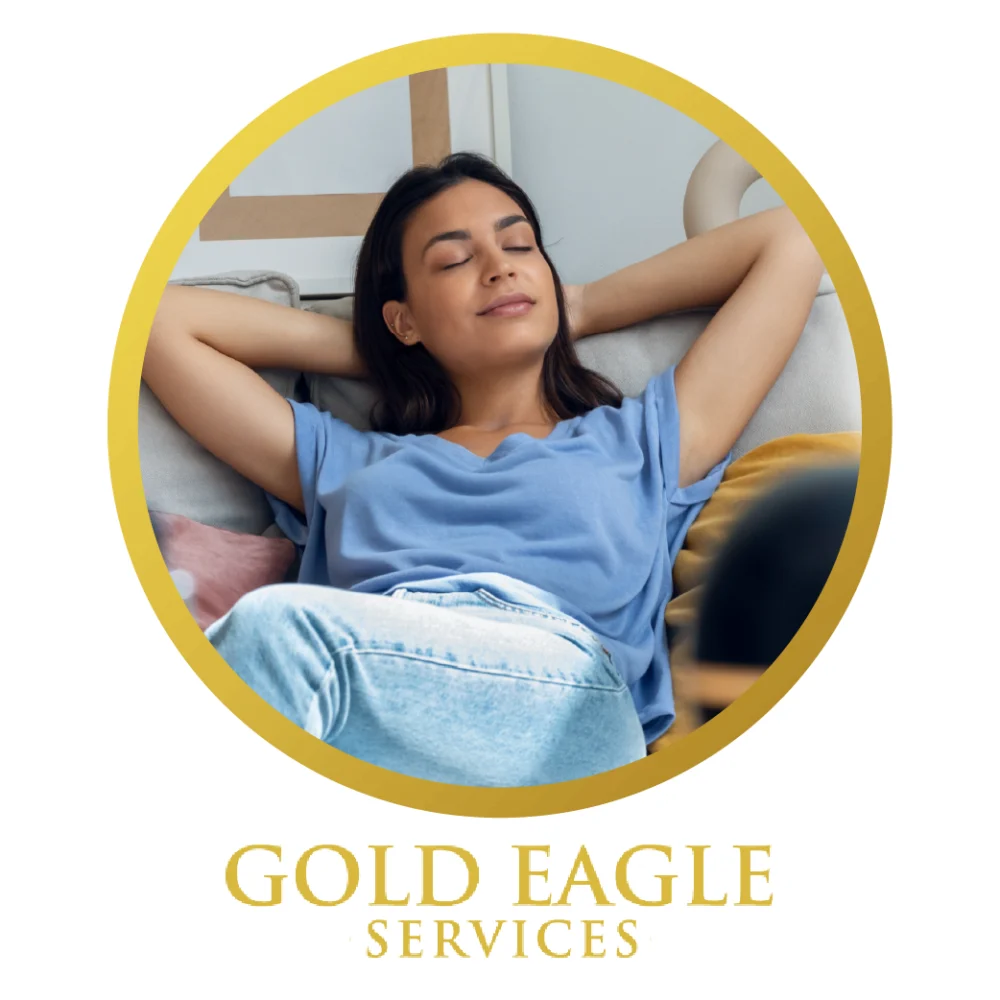 young woman sitting back with her arms rested behind her head with the gold eagle services logo at the bottom of the image