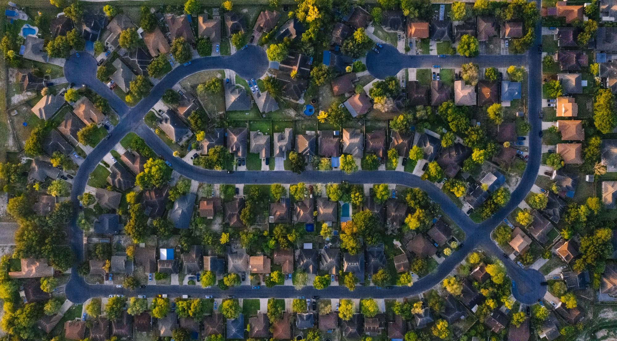 Aerial view of a tree-lined suburban neighborhood in Texas