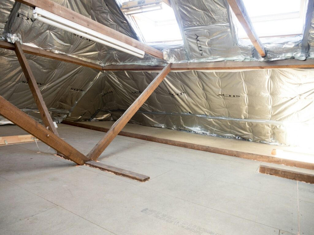 Attic with foil insulation under the roof deck and wood trusses