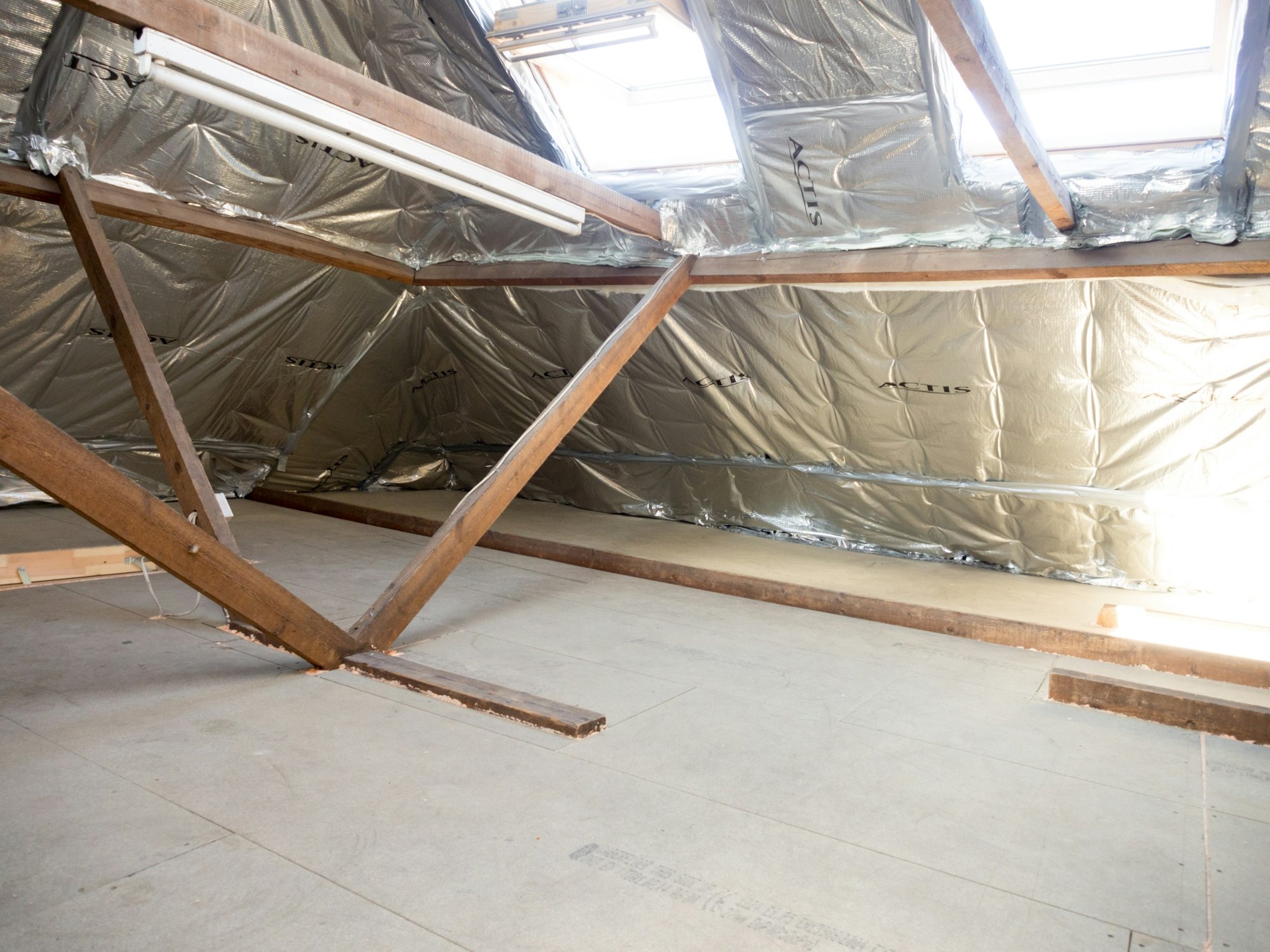 Attic with foil insulation under the roof deck and wood trusses
