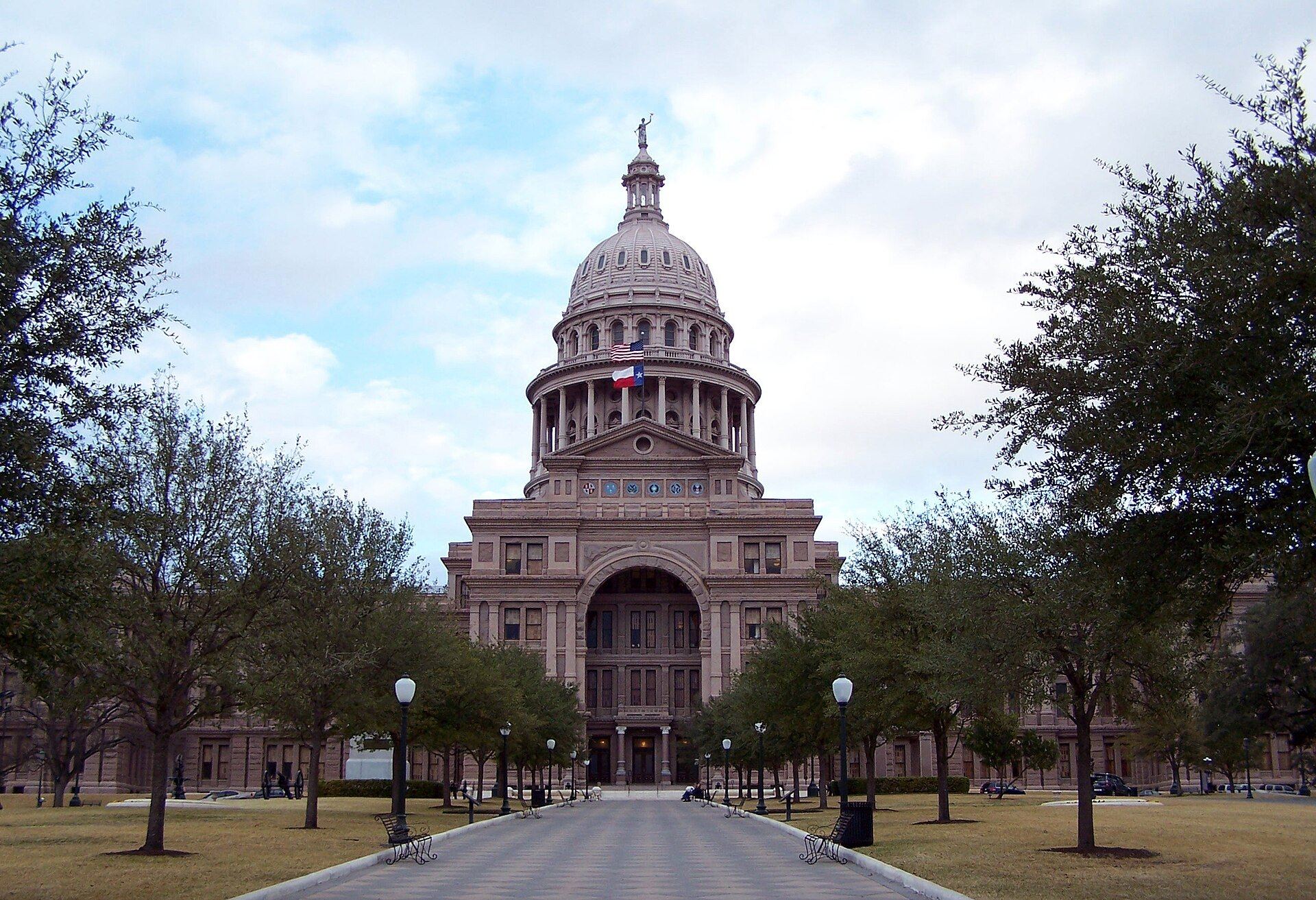 Texas State Capitol dome at the end of the tree-lined south walk in Austin, Texas