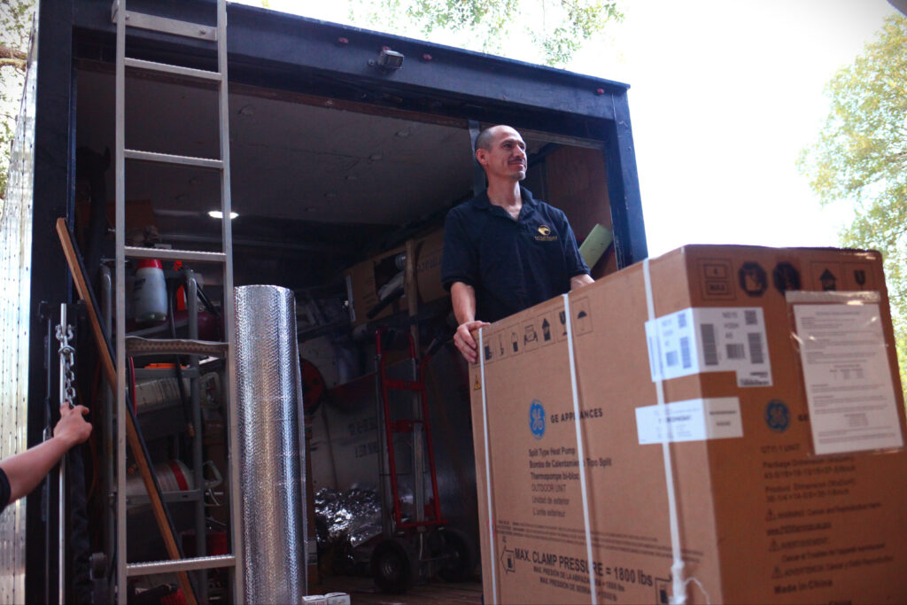 Gold Eagle Services HVAC installer loading an air handler