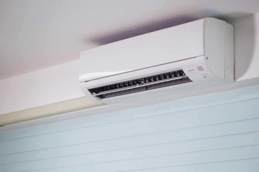 Ductless mini-split air conditioner mounted high on an interior wall