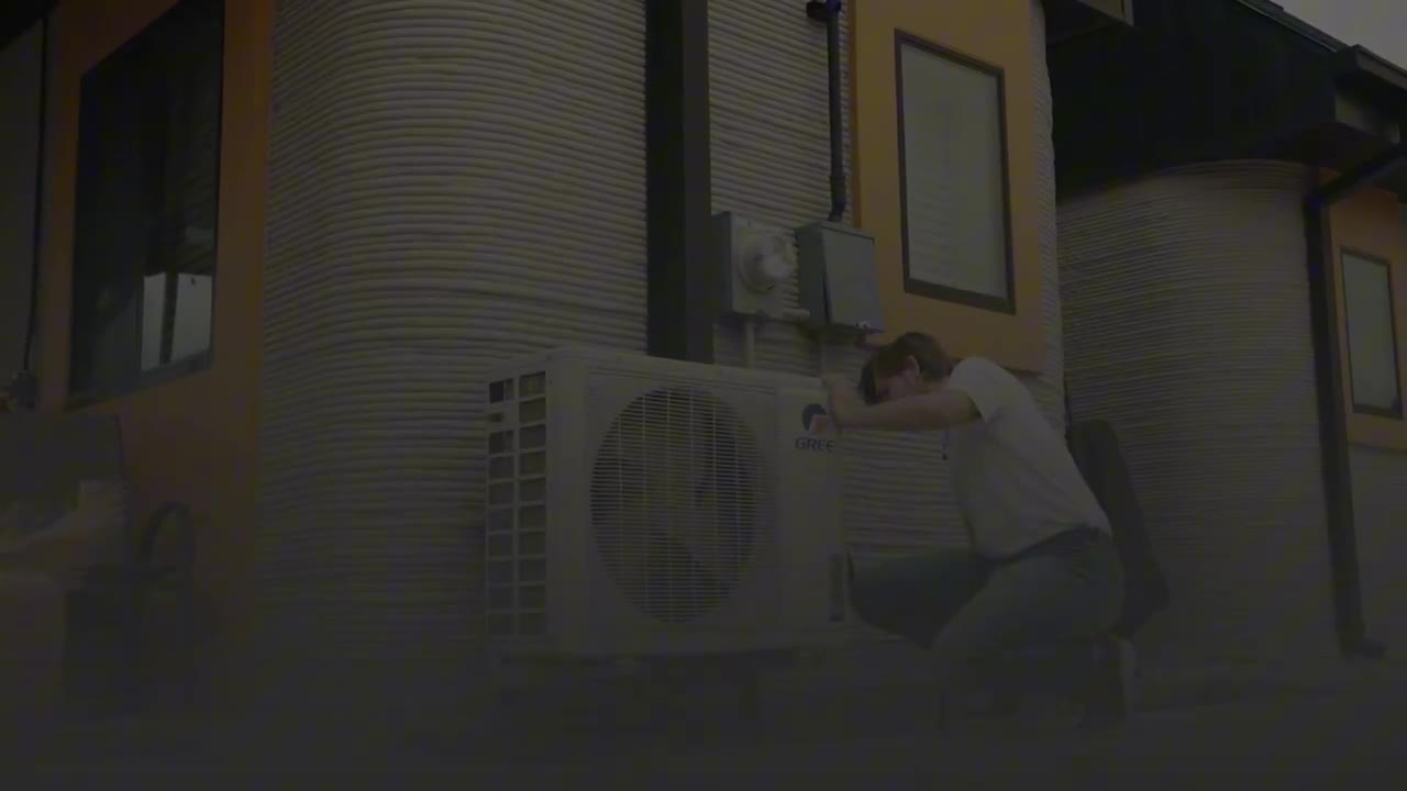 Gold Eagle Services technician servicing an outdoor heat pump at an Austin home