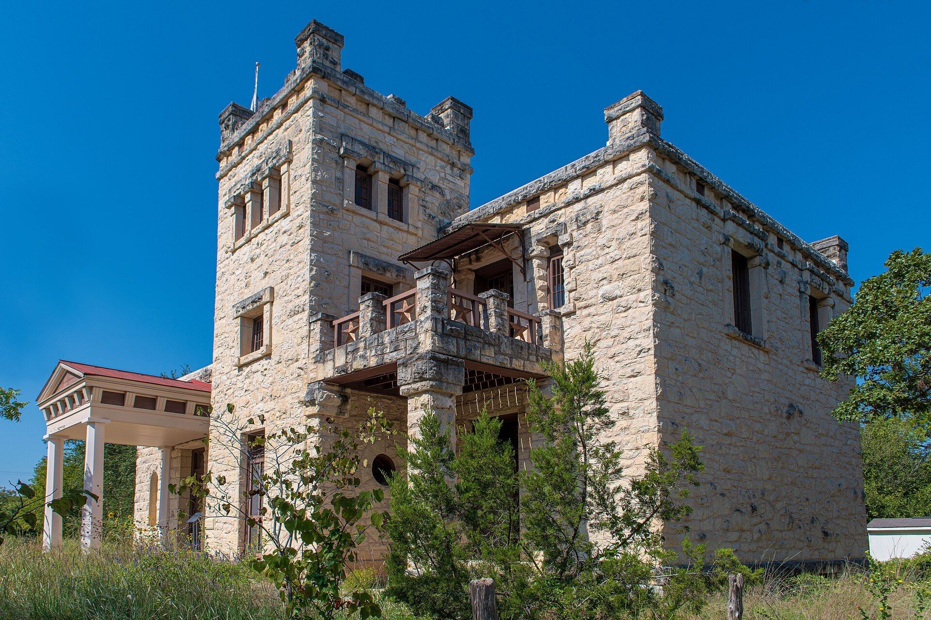 Limestone towers of the Elisabet Ney Museum against a deep blue sky in Hyde Park, Austin, Texas