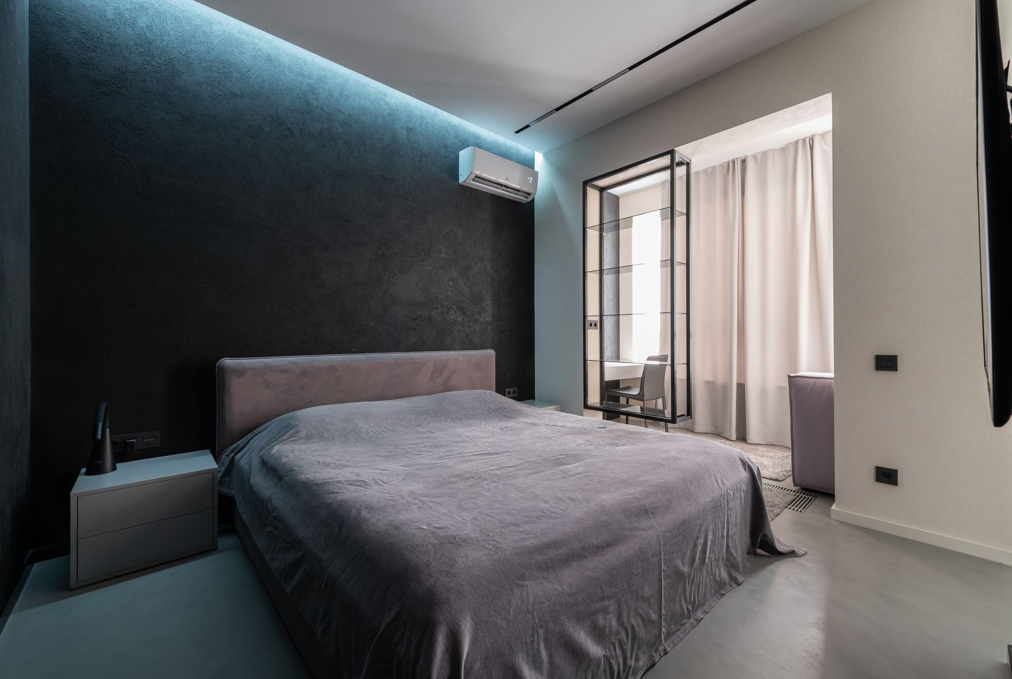 Modern bedroom with a ductless mini-split air conditioner on the wall