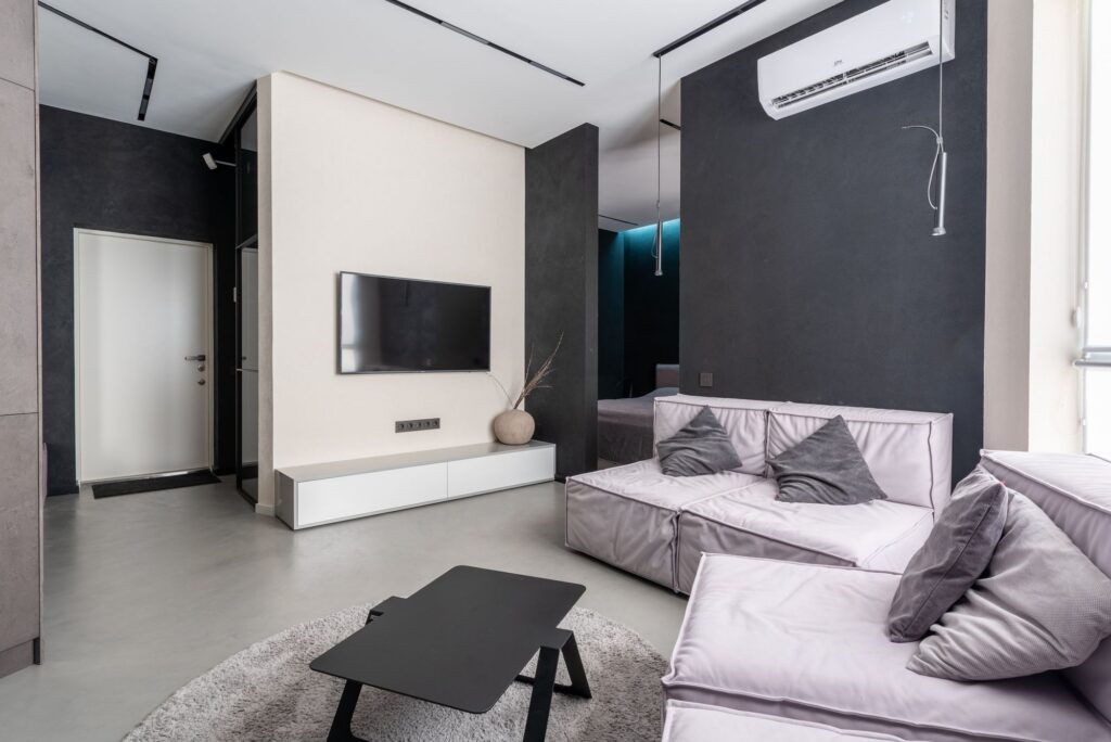 Open living room with a ductless mini-split unit mounted high on the wall
