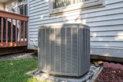 new air conditioning unit next to a home patio”